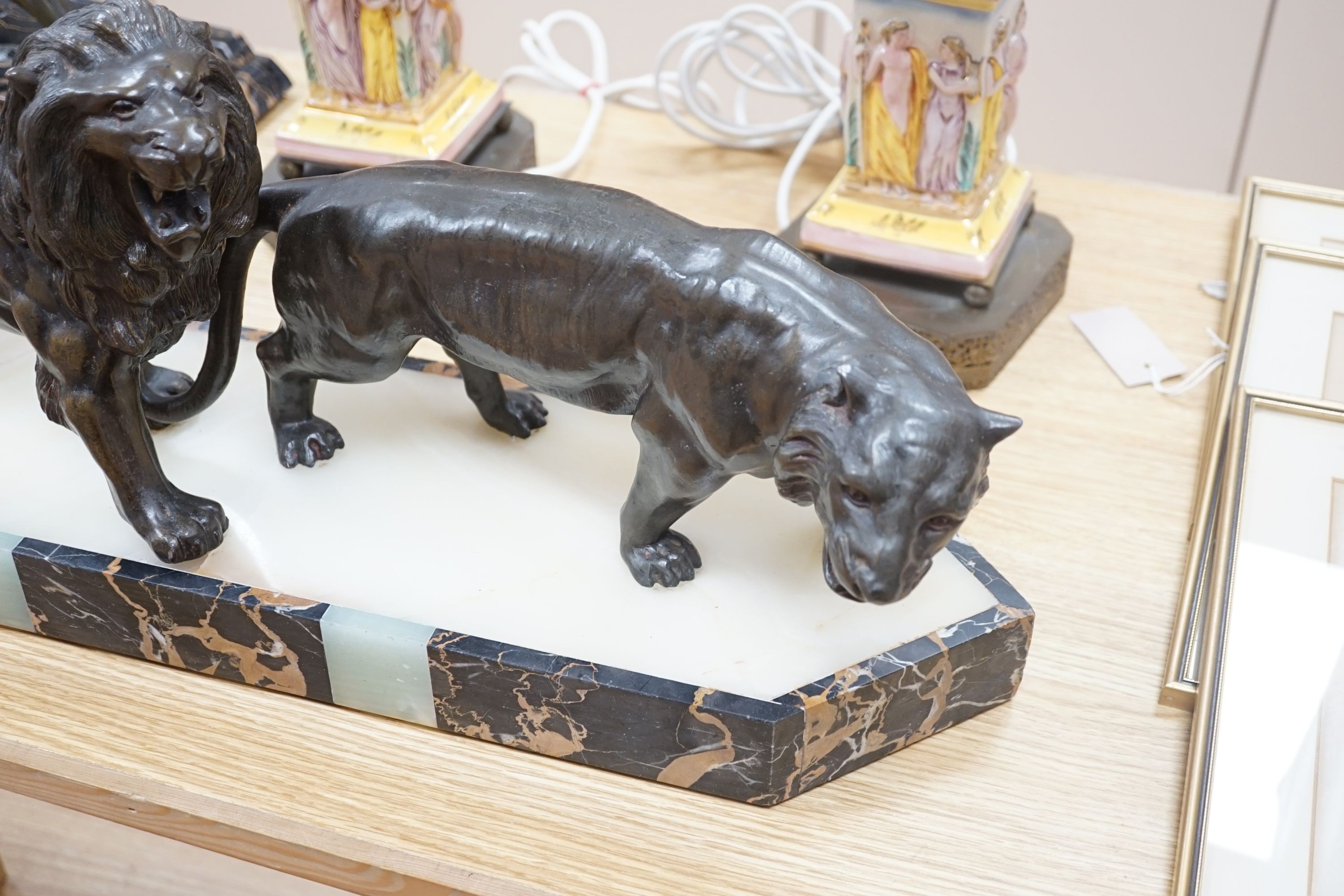 An Art Deco bronzed metal, marble and onyx group of lion and lioness, signed Benaca, 67cm